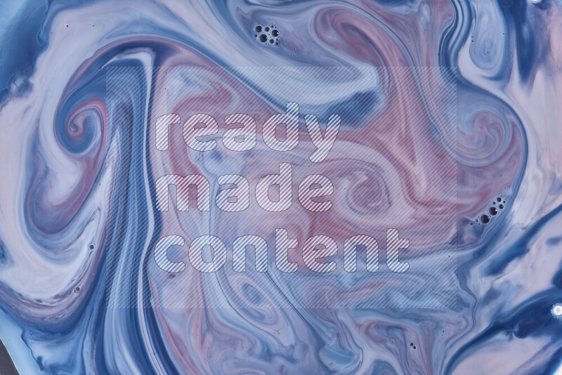 A close-up of abstract swirling patterns in blue, red and white
