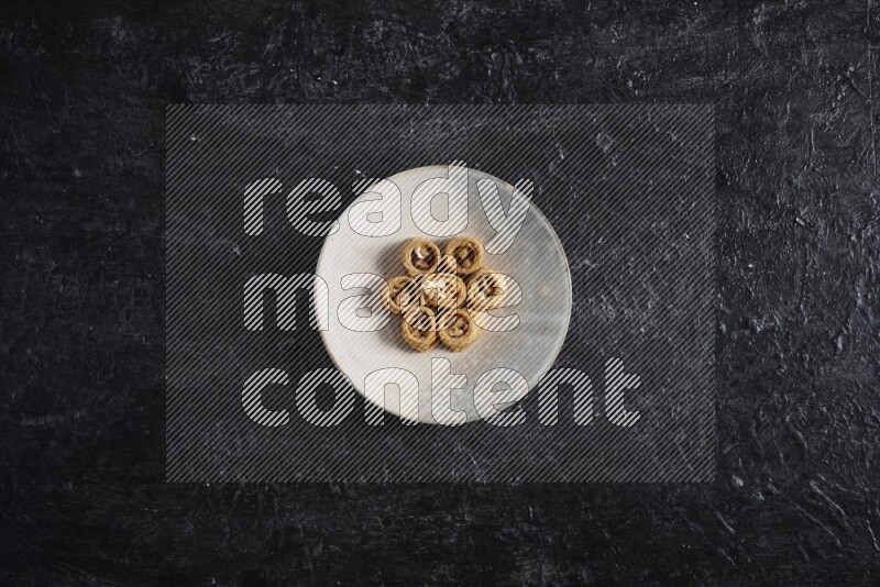 Konafa in a pottery plate in a dark setup