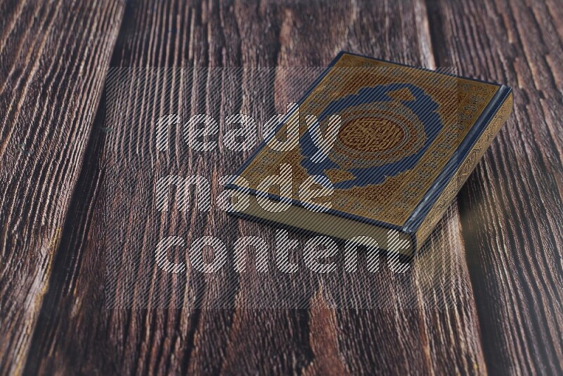 Quran with a prayer beads on wooden background