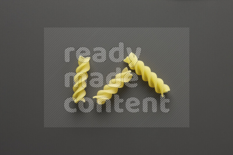 Fusilli pasta on grey background