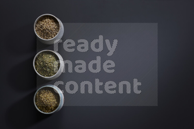 Legumes in pottery bowls on grey background