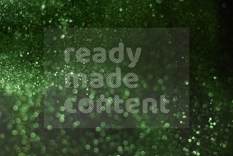 Green glitter powder isolated on black background