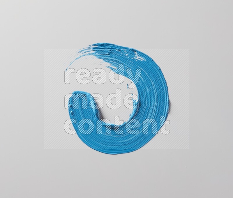 A single blue curved brush stroke on a white background