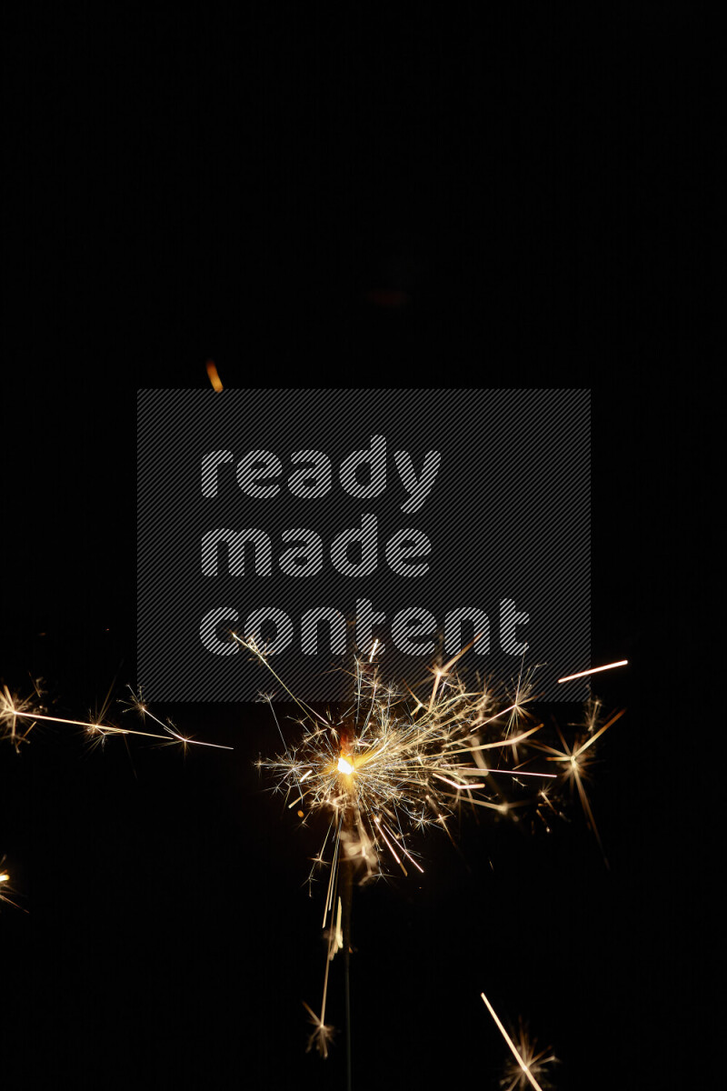 A close-up image of sparkler candle isolated on black background