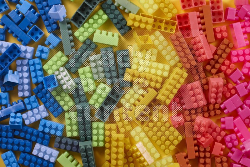 Multicolored plastic building blocks on different backgrounds (kids toys)
