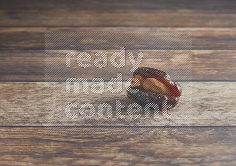 almond stuffed madjoul date on a wooden background