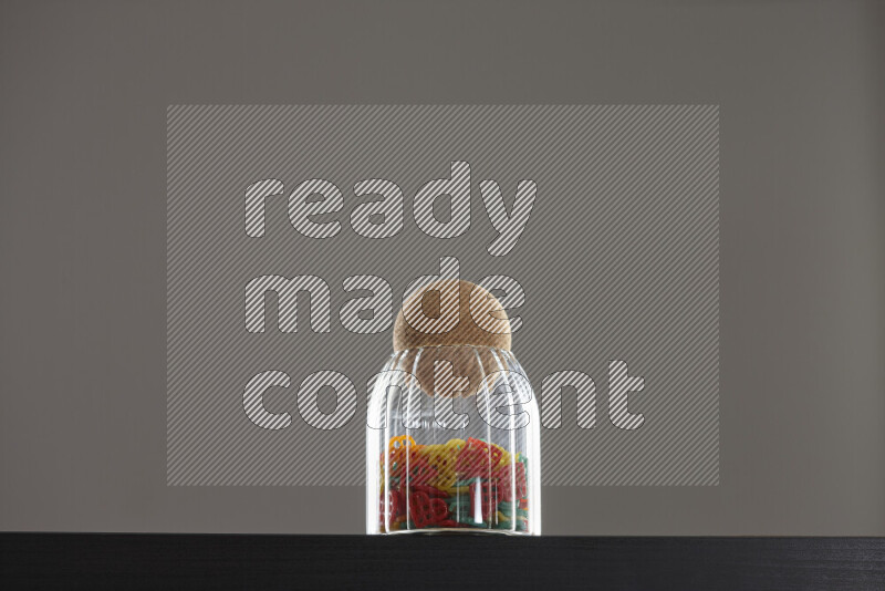 Snacks in a glass jar on black background