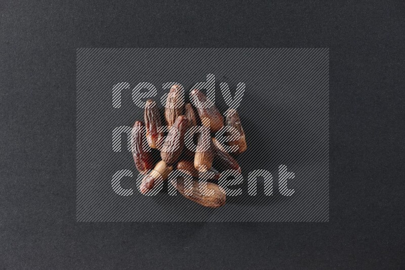 Dried dates on a black background in different angles