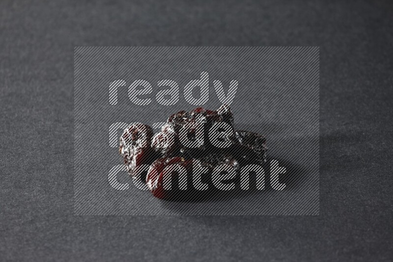 Dried plums on a black background in different angles