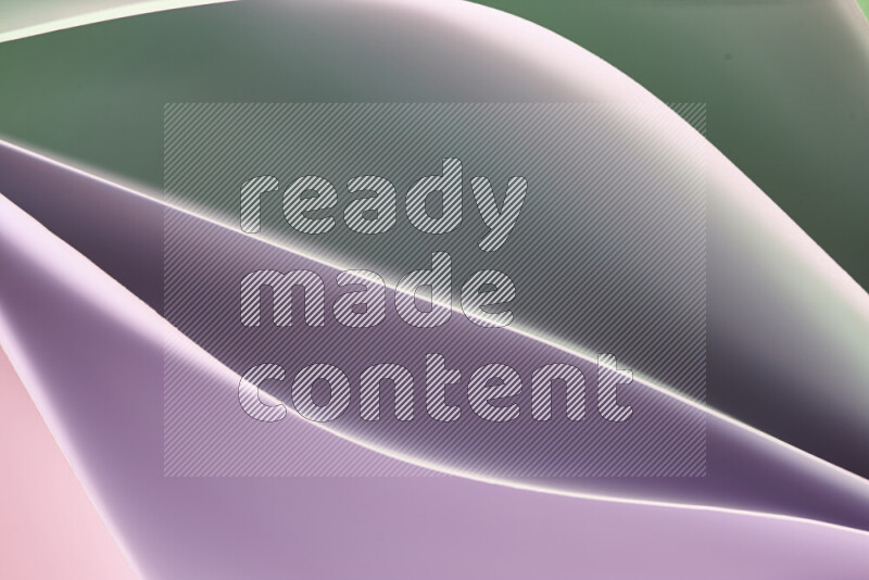 This image showcases an abstract paper art composition with paper curves in green and pink gradients created by colored light