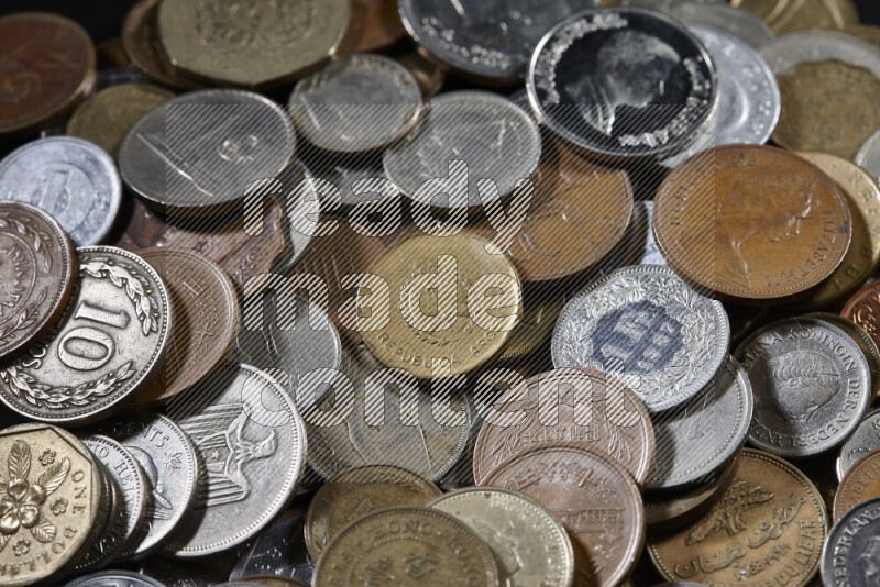 A close-ups of random old coins on black background