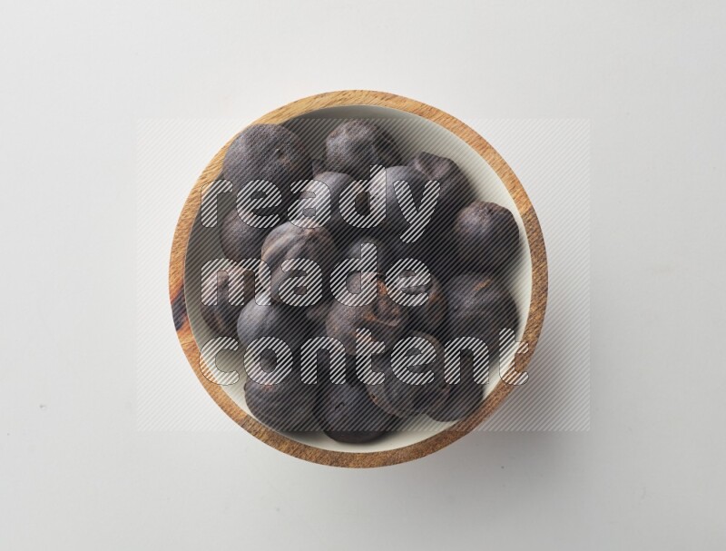 Top-view shot of dried lime (loomi) in a container on white background