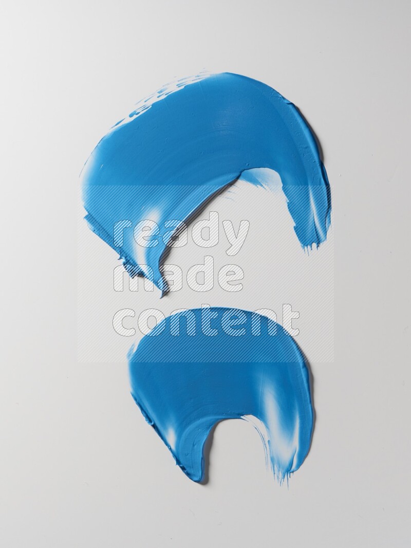 Blue curved painting knife strokes on white background