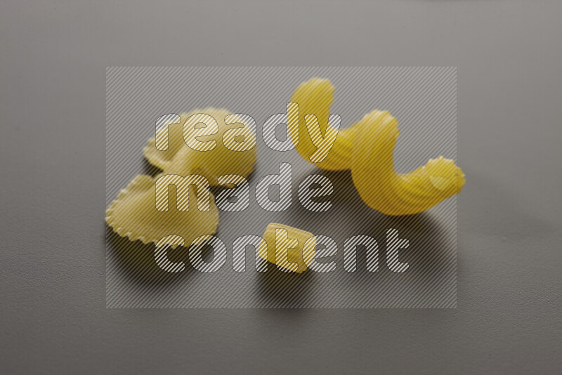 Different pasta types on grey background