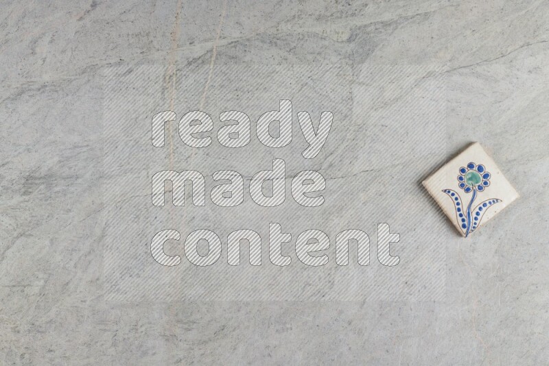 A decorative pottery coaster on grey marble background