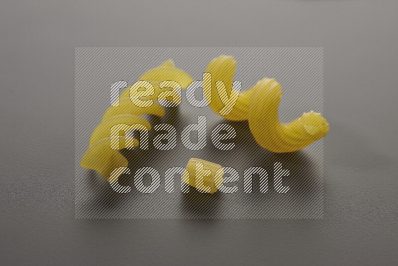 Different pasta types on grey background