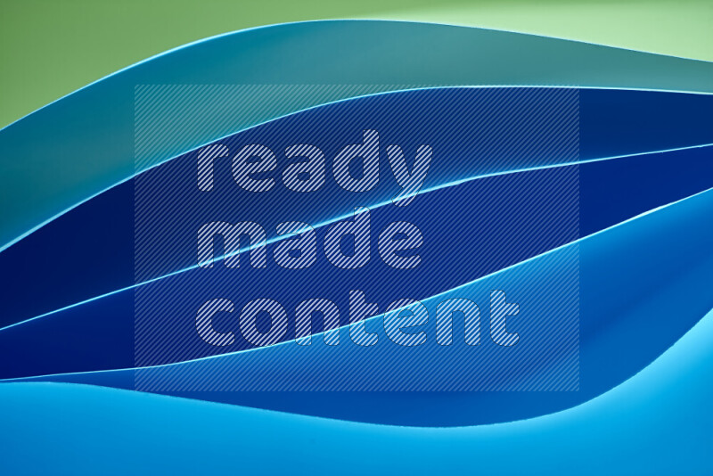 This image showcases an abstract paper art composition with paper curves in green and blue gradients created by colored light