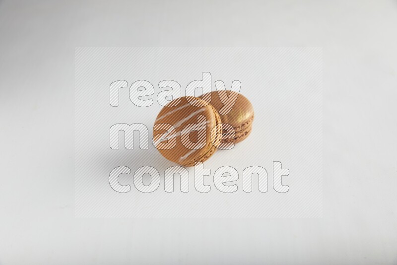 45º Shot of of two assorted Brown Irish Cream, and Brown Coffee macarons  on white background