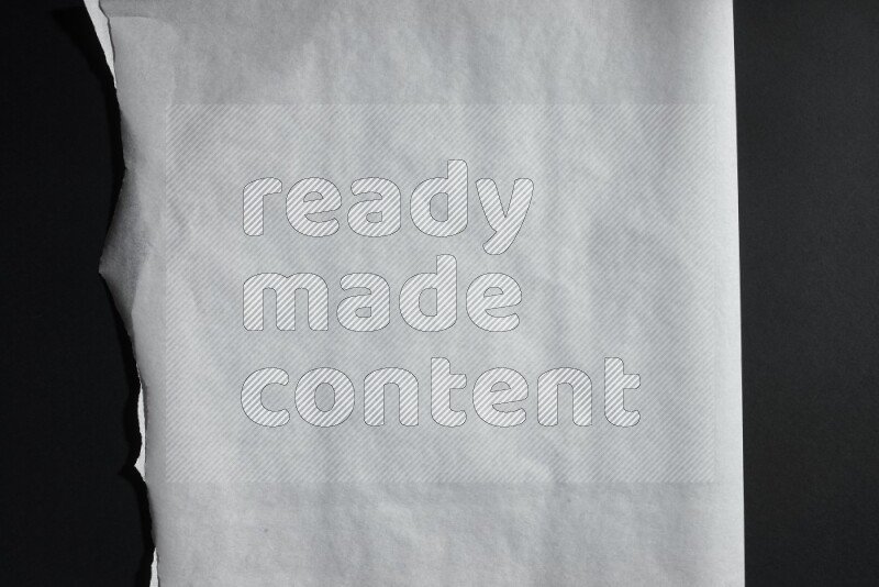 White paper sheet on black background