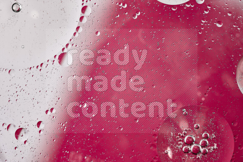 Close-ups of abstract oil bubbles on water surface in shades of white and pink