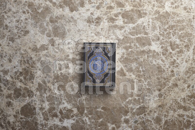 The holy Quran on beige marble background