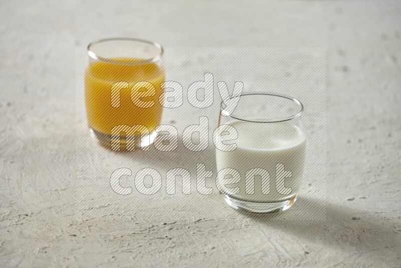 Cold drinks in a glass cup such as water, tamarind, qamar eldin, sobia, milk and hibiscus on textured white background