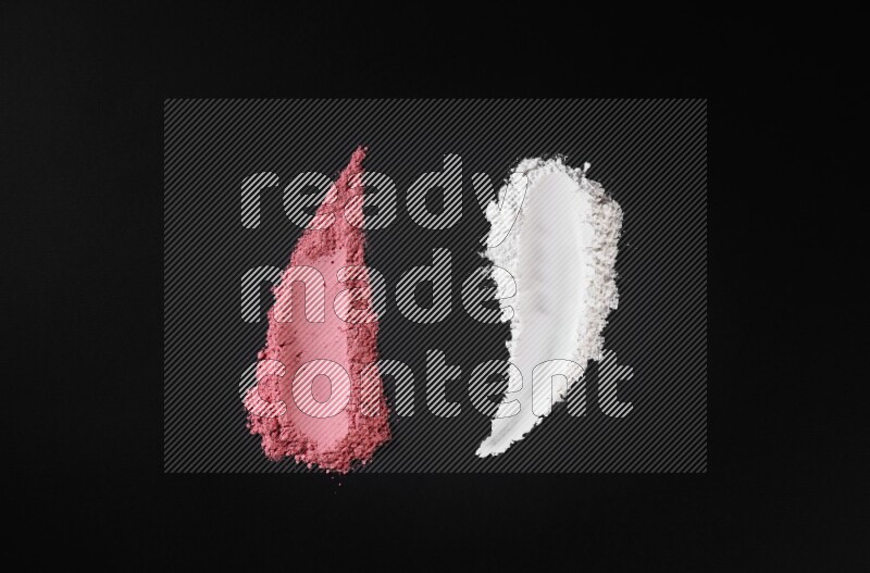 Multicolored powder smears on black background