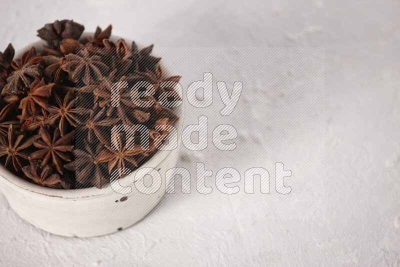 Star Anise in a white bowl on white background
