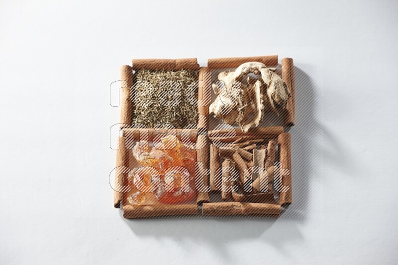 4 squares of cinnamon sticks full of cumin, cinnamon, dried ginger and gum arabic on white flooring