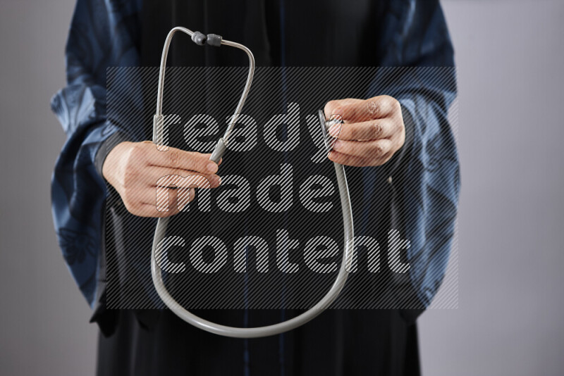 Female doctor wearing an abaya and medical attire in different positions