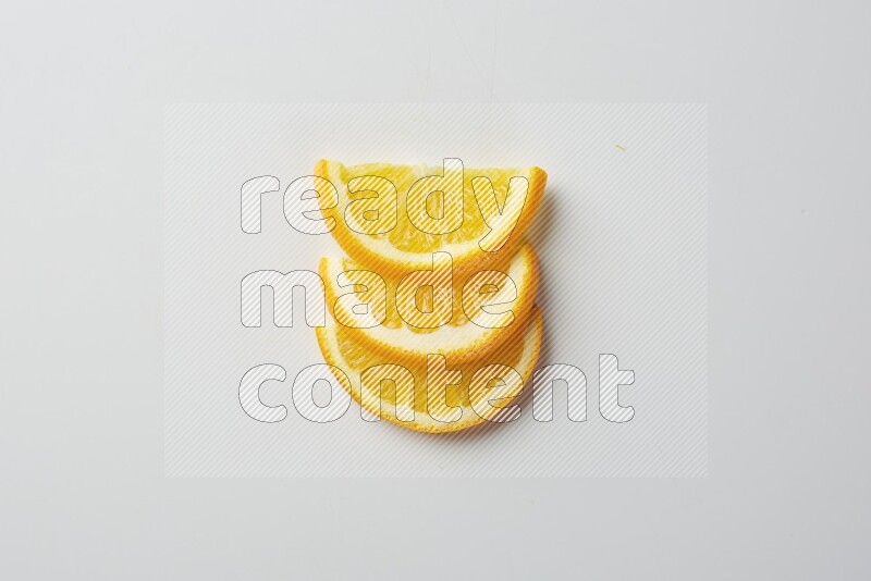 Three halves of an orange slices on white background