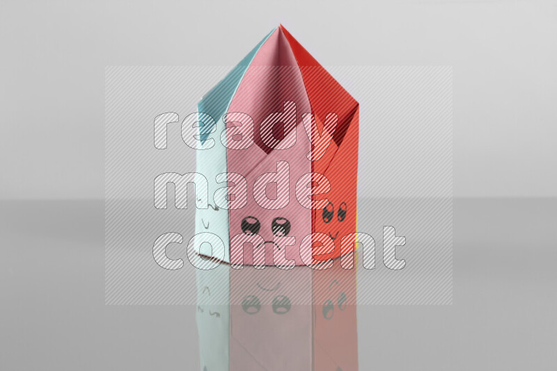 Origami pen holder on grey background