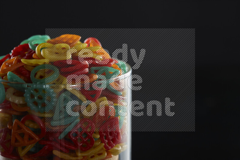 Snacks in a glass jar on black background