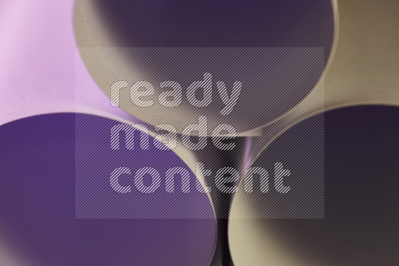 The image shows an abstract paper art with circular shapes in varying shades of purple