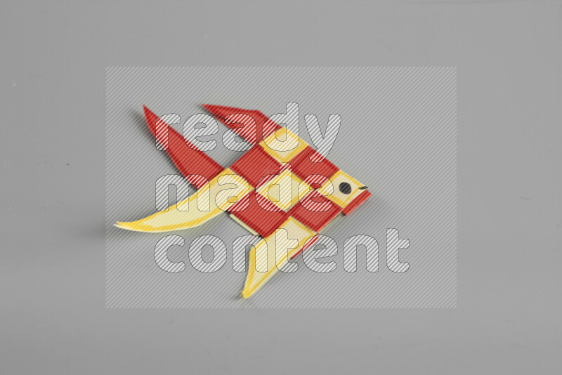 Origami fish on grey background