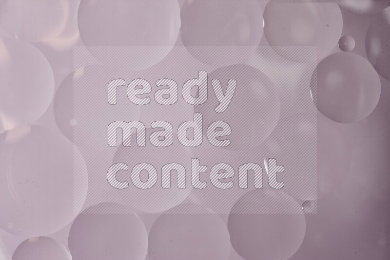 Close-ups of abstract oil bubbles on water surface in shades of grey