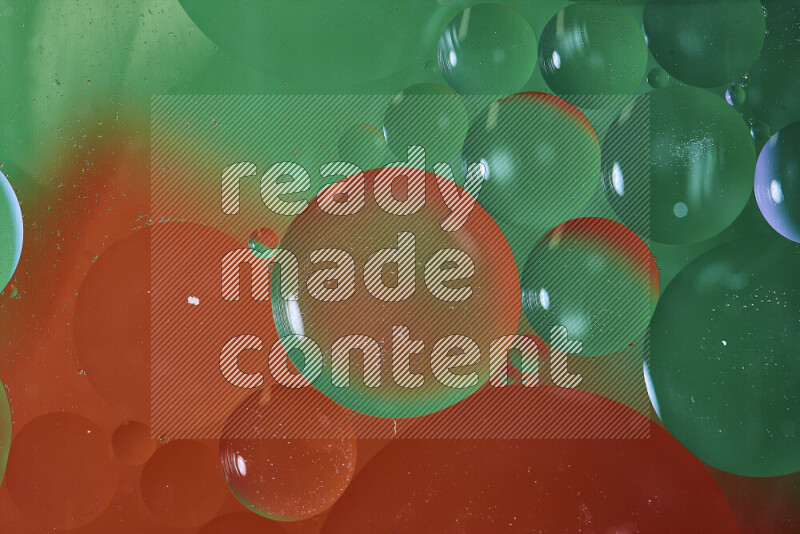 Close-ups of abstract oil bubbles on water surface in shades of green and red