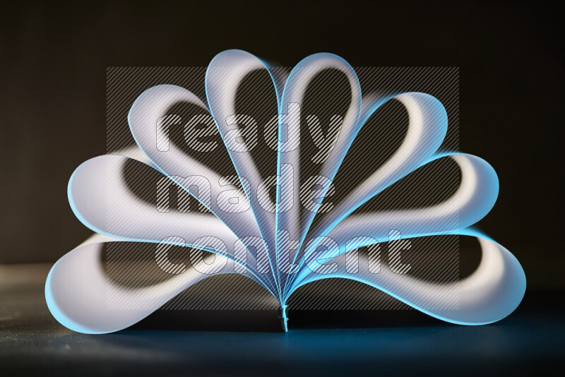 An abstract art piece displaying smooth curves in blue and white gradients created by colored light
