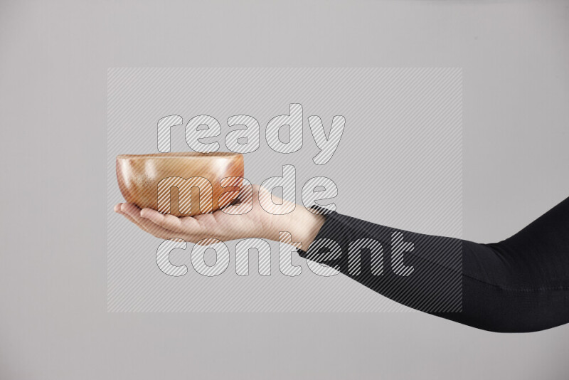 امرأة ترتدي عباءة سوداء تحمل أدوات خشبية مختلفة في أوضاع متعددة