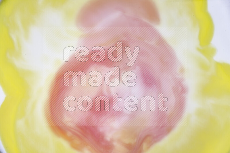 A close-up of abstract swirling patterns in yellow, red and white