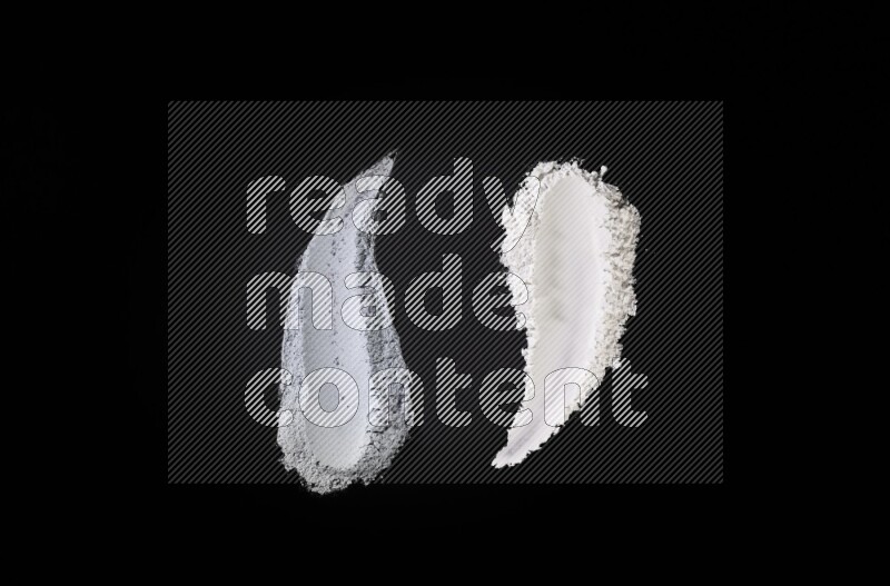 Multicolored powder smears on black background