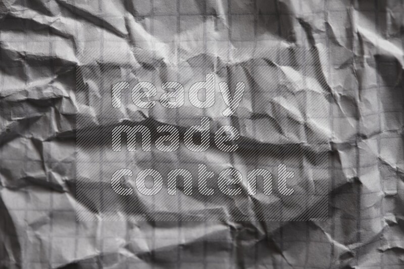 Crumpled notebook sheet on black background