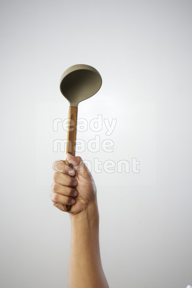 Male Hand Holding ladle on white background