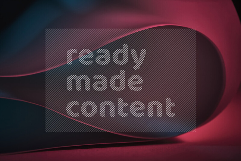 An abstract art piece displaying smooth curves in blue and red gradients created by colored light