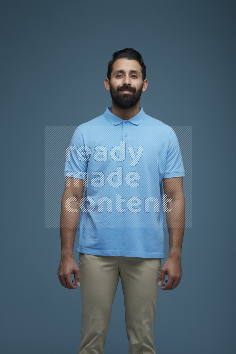 Man posing in a blue background wearing a Blue shirt