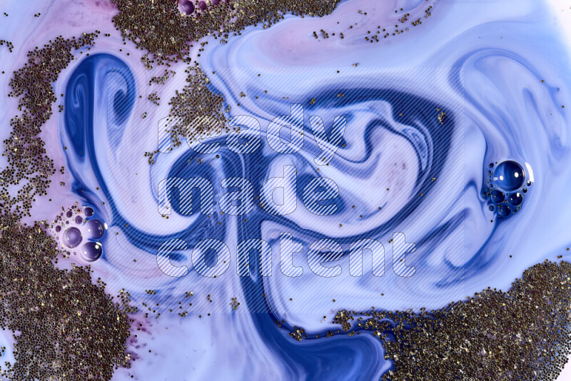 A close-up of sparkling gold glitter scattered on swirling blue and red background