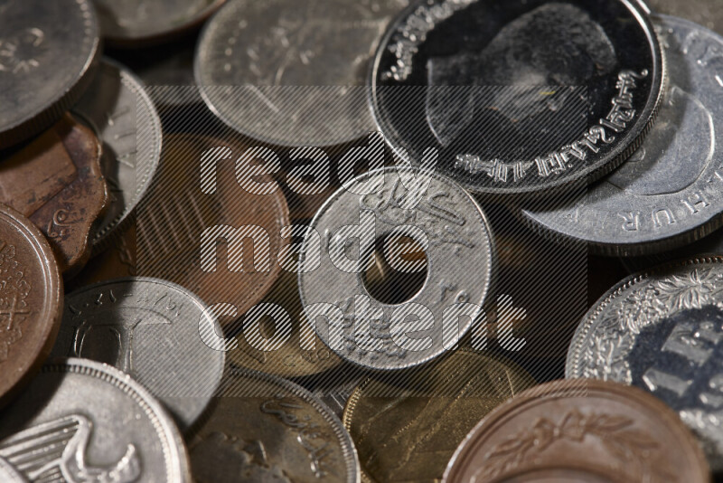 A close-ups of random old coins on black background