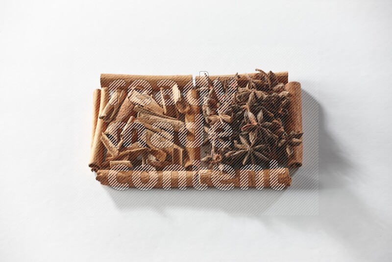 2 squares of cinnamon sticks full of star anise and cinnamon on white flooring