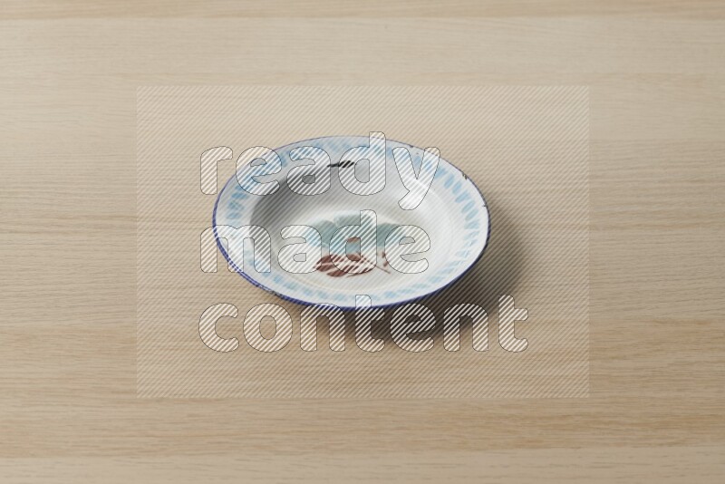 A vintage metal plate on light wooden background