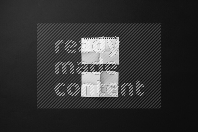 Ripped notebook sheet on black background